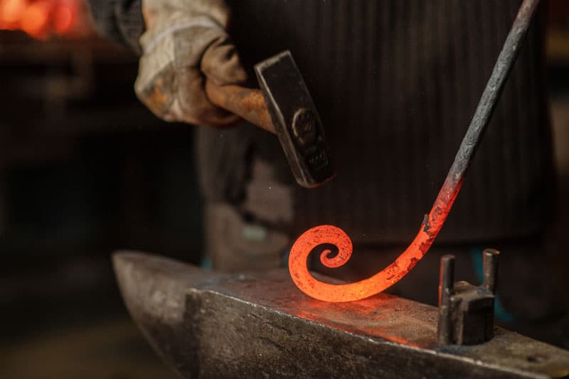 forging a piece of iron with precision